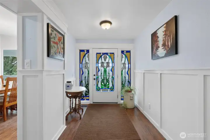 Main level entry has beautiful stained glass, woodwork along the walls with elegance and charm. This entry is a craftsmanship delight!