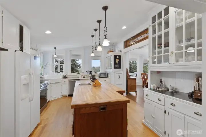 View of the kitchen looking towards the sink and windows that over look the covered porch