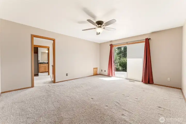 Primary bedroom with slider to backyard