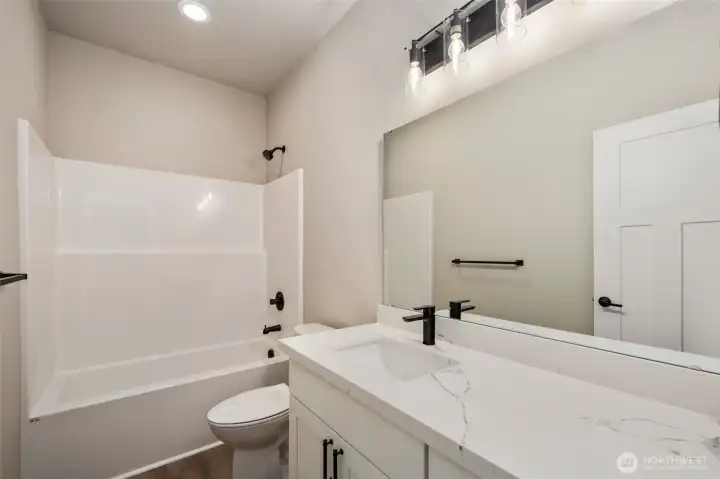 Downstairs full bath. Quartz counters!