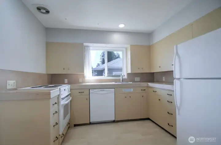 Enough space and windows on either side lets natural light brighten the kitchen