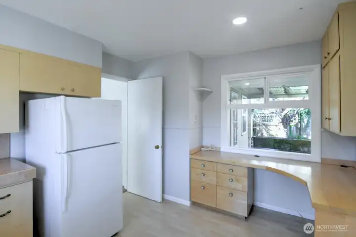 Door to hide the food prep/mess- a common mid-century feature that's making a comeback w/"back kitchens". Space to renovate in many ways.