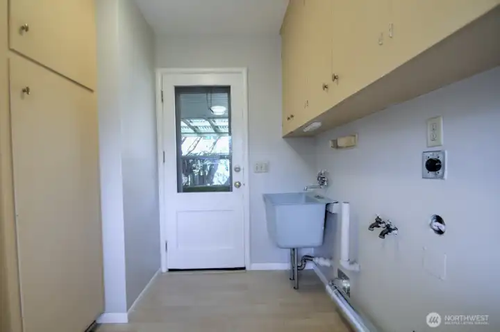 Other side of Utility/Laundry room w/Washer & Dryer hookups, door to covered patio