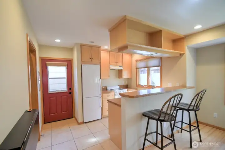 Use of light wood and tile gives this studio an even bigger, brighter feel. Fold-away table on left example of the custom- and practical, finish work