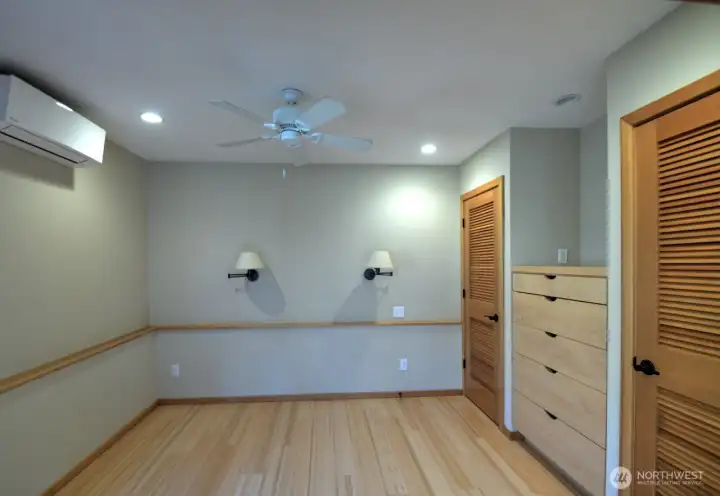 Looking into bedroom area. Notice again the great add of custom drawers between two(!) closets, and sconce lighting