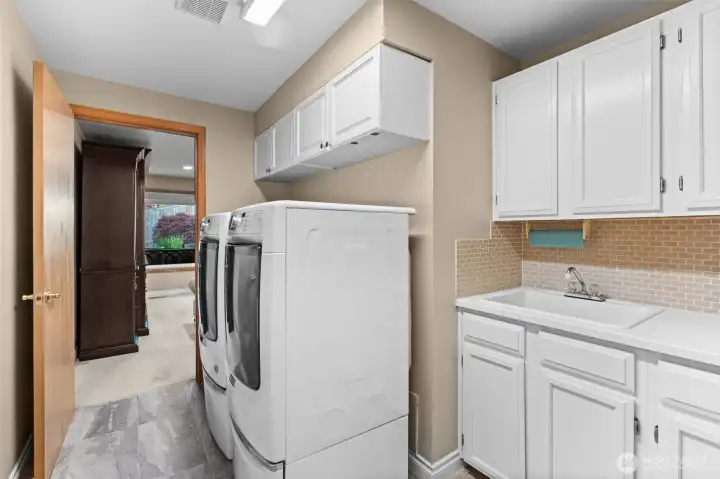 What a laundry room! Gas dryer and tons of cabinets
