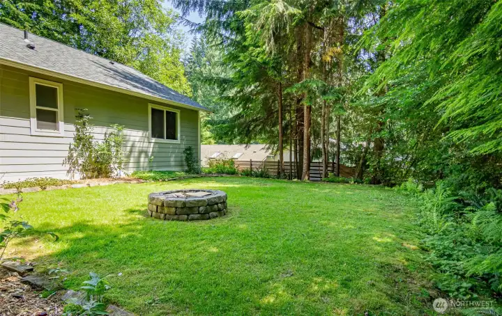 The level back yard provides space to play - and there is a fire pit too! The level back yard provides space to play - and there is a fire pit too!