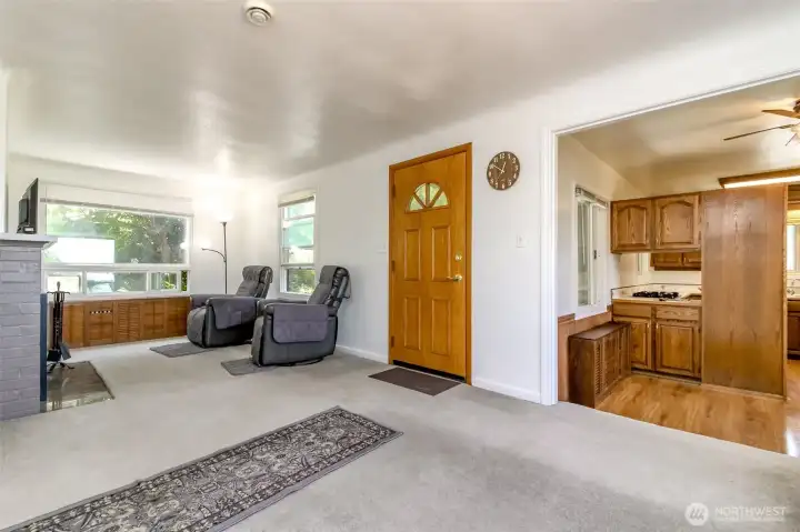 Looking into living area, front door and into kitchen area Looking into living area, front door and into kitchen area