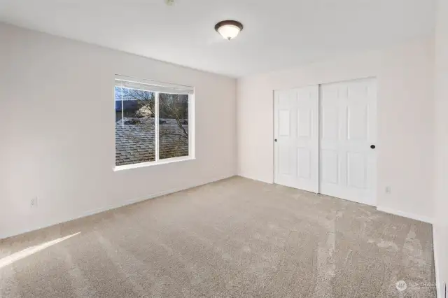 Second bedroom overlooks the garages. Lots of light in here as well.