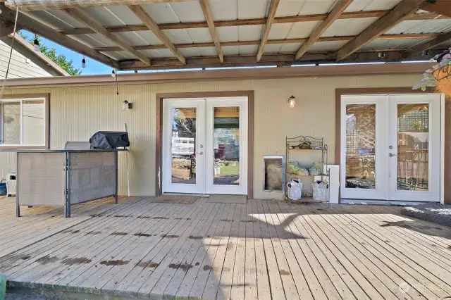 Back deck: french doors lead to the dining area and primary bedroom.