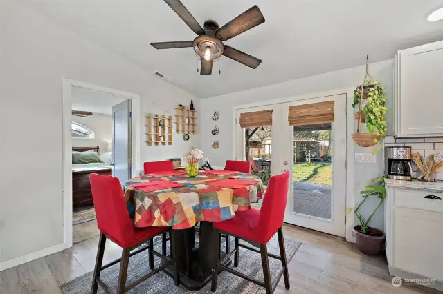 Dining area off the kitchen with French doors that lead out to the back deck and yard.