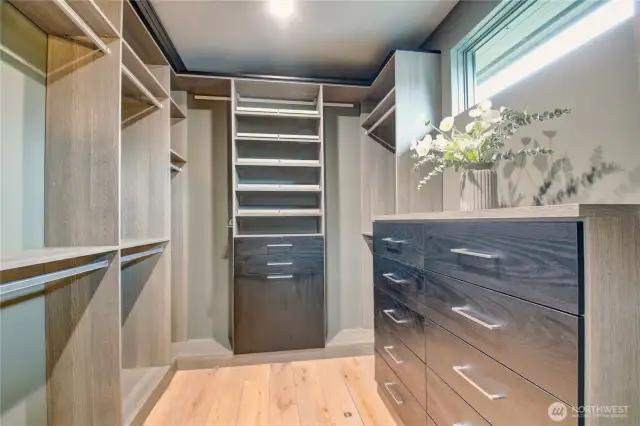 California Closets throughout. This spacious wardrobe closet offers built in jewelry drawers and clothes hamper.