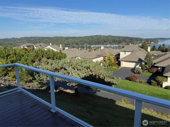 Relax outside and inside with abounding views of water.  Mountain views to the west also abound throughout this home.