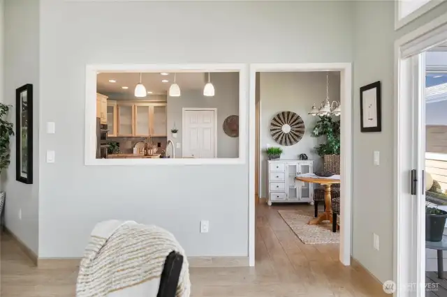 Kitchen entry from living room and dining area. Sliding unit to right is access to trex deck that wraps around to back of home