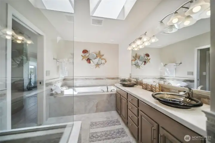 Large primary bathroom with separate shower and oversized bathtub