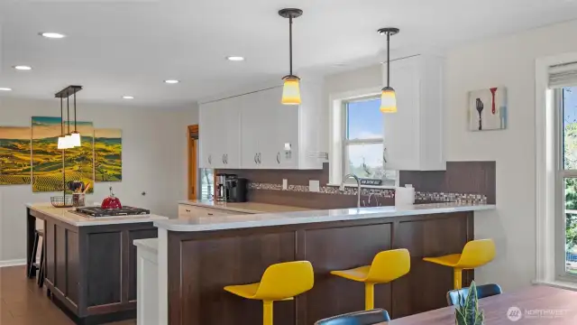 The large, chef's kitchen makes room for several cooks at once and includes both a breakfast bar and eat-in counter space.