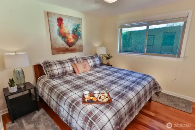 The second upstairs bedroom is shown here with a king bed. It sits adjacent to a full bathrooom.