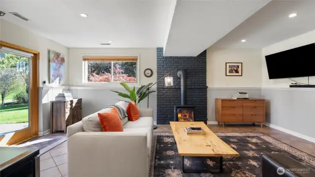 The walk-out lower level has plenty of light but is also appointed with black-out shades for movie nights or if guests are sleeping over on the pull-out couch. Gas stove cozies up the room in a flash!