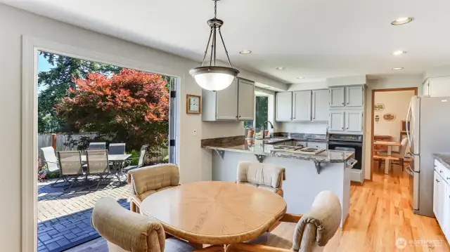 Enjoy an informal dining space just off the kitchen with french doors to the 16'x26' herringbone paver stone patio out back for indoor/outdoor living all summer long!