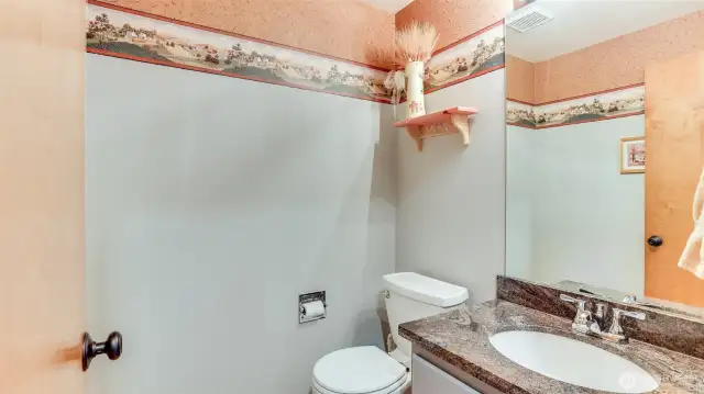 Half bath on the main floor with newer granite counters.