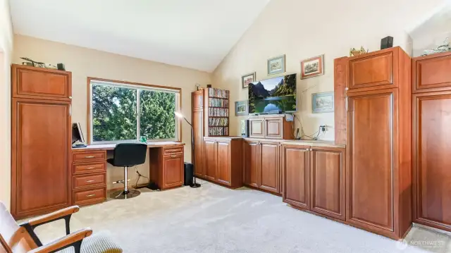 This bonus space is just off the primary and creates a wonderful option for home office, craft space, media room and boasts luxurious built-in cherry cabinets.