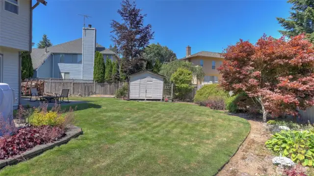 Enjoy the coral bells, hardy fuchsia, varied Japanese maple trees, clematis, blue bells, hostas and candy tuft throughout this park-like backyard.