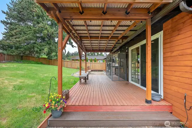 Expansive covered deck with sliding glass door access—ideal for indoor-outdoor living year-round.