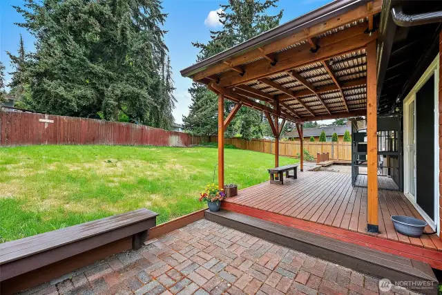 From the patio looking out—this view invites you to sit back, sip your coffee, and enjoy the serene, fully-fenced backyard with plenty of room to roam.