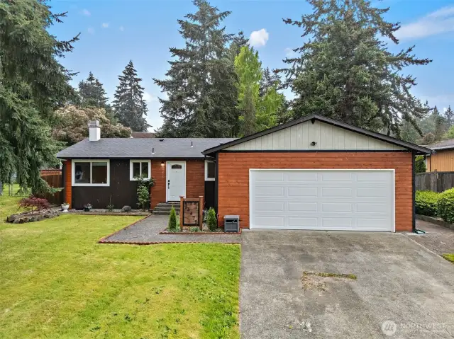 Curb appeal for days! This updated home blends modern finishes with warm cedar siding and a fresh white garage door—creating a cozy yet contemporary first impression.