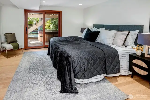 downstairs Primary with access to a hot tub and private backyard