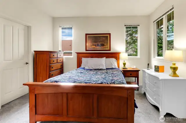Primary bedroom with North & South facing windows. Large enough for a King Size bed and with walk in closet an private and ensuite bath.