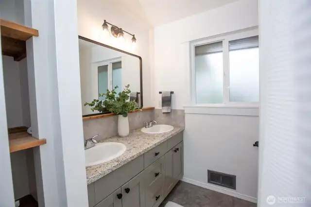 Hall full bath stylishly updated with finishes that give a nod to the home's vintage.