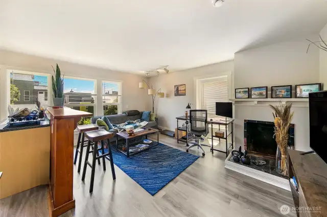 Apartment 2 – Two-Story Living with Historic Soul  One of Laurel Gate’s most spacious offerings, Apartment 2 spans two levels and features two fireplaces—including a freestanding gas unit. Original fir floors, abundant windows, and a generous living/dining area create an inviting, flexible space. A reclaimed cedar bar from a historic Lake Union houseboat adds a signature touch, blending whimsy with authenticity in this one-of-a-kind Capitol Hill apartment.