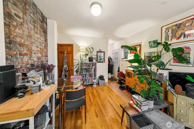 Apartment 5 – Quiet Comfort with Character Touches  Tucked at the rear of the first floor with its own small deck, Apartment 5 pairs privacy with warmth. Exposed brick, oak floors, and colorful, personalized décor reflect the building’s creative spirit. A simple, smart layout and tranquil garden-side orientation make this one-bedroom ideal for long-term tenants seeking charm and convenience in equal measure.