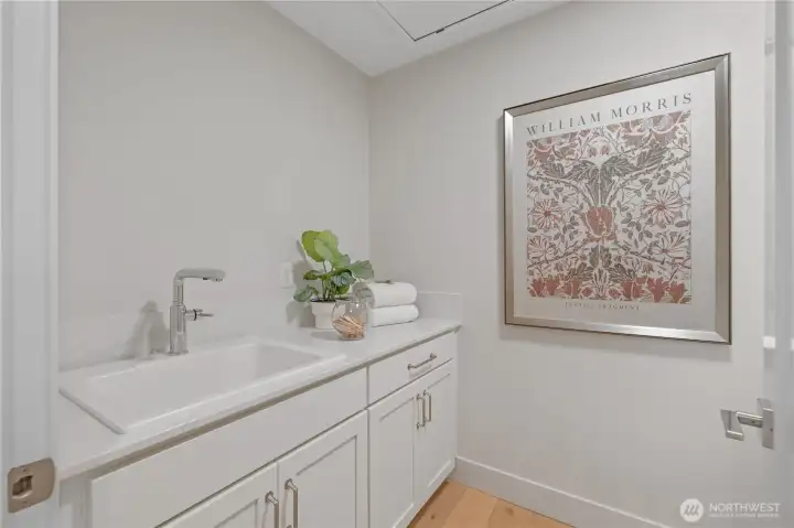 Laundry room with sink and cabinets. Photos are for illustration purposes only; colors and finishes will vary. Photos are of the model home at Bentley on lot 4.
