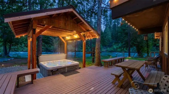 Covered hot tub pavilion provides a year-round spa experience, perfectly positioned to capture the natural beauty and privacy of the riverfront setting. Covered hot tub pavilion provides a year-round spa experience, perfectly positioned to capture the natural beauty and privacy of the riverfront setting.