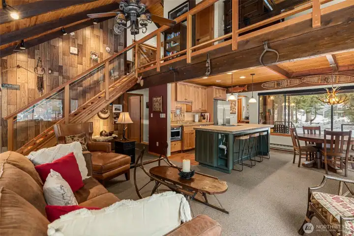 Open Concept with custom wood stairs to upstairs bedroom and loft