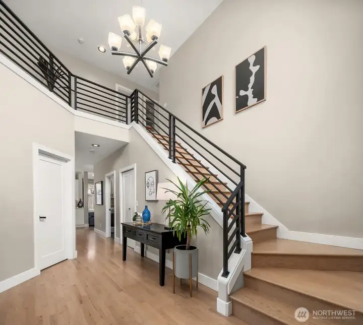 A welcoming 2-story entry with a contemporary steel handrail sets the tone for gathering & connection.