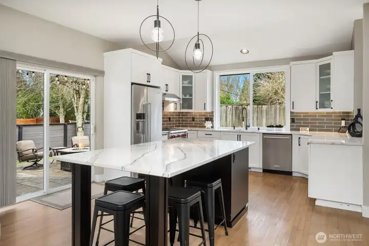 Multiple doors lead to the private fully fenced 8,349sf  CORNER LOT with mature landscaping and a custom paver patio—ideal for PLAY, pets, and outdoor ENTERTAINING.