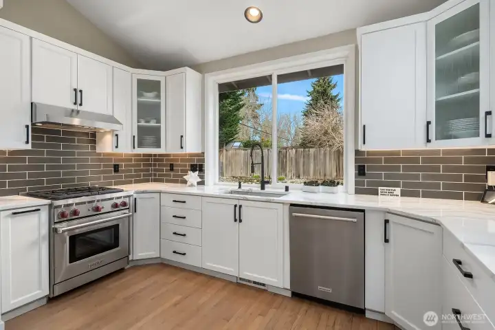 Wolf & KitchenAid appliances+beverage cooler and microwave drawer.