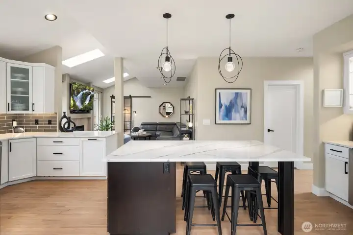 Hardwood floors, vaulted ceilings, Cambria quartzite, and soft neutral tones create a warm, modern feel throughout.