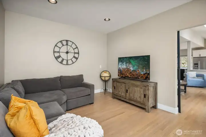 A huge home office / bonus room with a striking metal-and-glass door