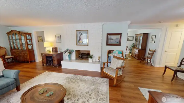 Looking in from the front door, you are greeted by gorgeous flooring, an electric fireplace, and nice architectural detailing