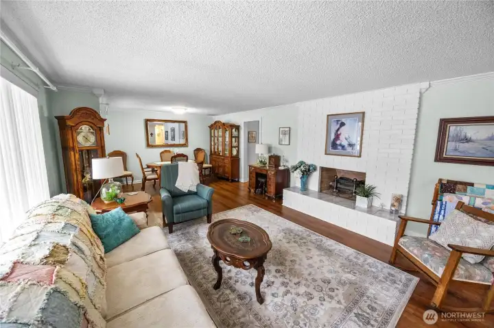 The large living room/dining room combo features beautiful flooring, base and crown molding, and an electric fireplace- perfect for those evenings when you want instant gratification, and charming ambiance, without building a fire.