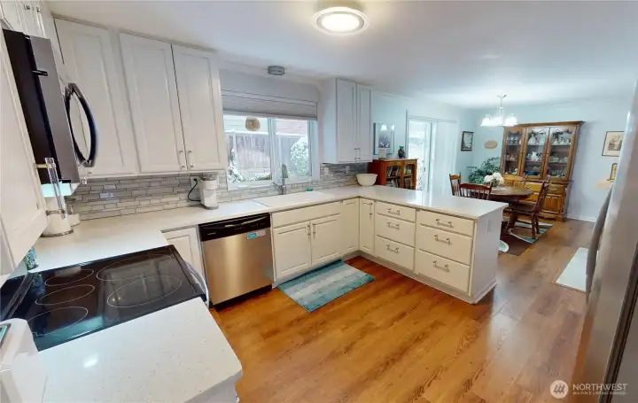 I love a slab countertop- less grout lines make for easier cleanup and less bacteria. Ample cupboard space is also a plus.