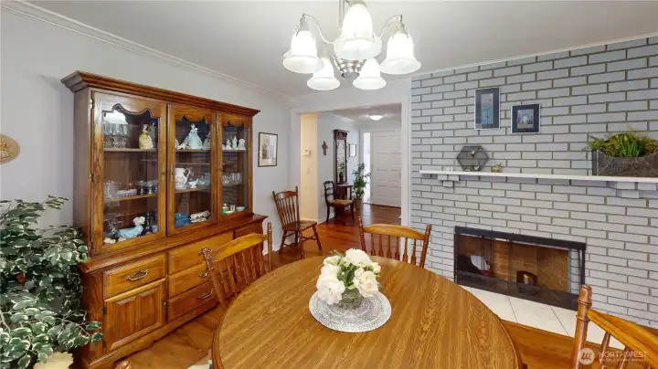 The "informal" dining area is located adjacent to the kitchen and off of the living room.  So cozy, with a wood burning fireplace, this is also a great place to visit, play cards,  or enjoy a cup of coffee and a bit of breakfast.