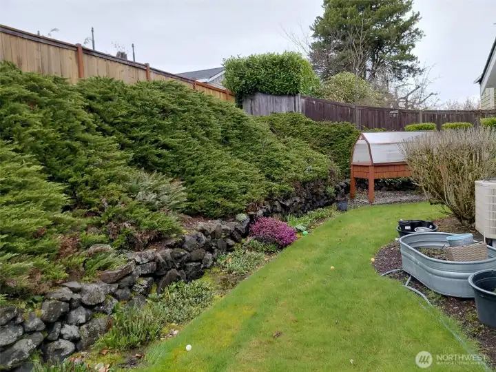 Your back yard is private and cozy with lovely lines and mature landscaping.