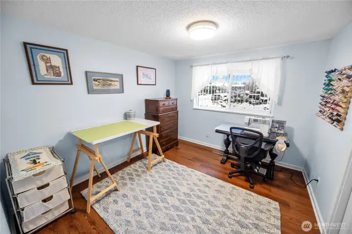 The third bedroom is currently used as a sewing room.  It, just like the other two bedrooms, features a large window and good closet space.