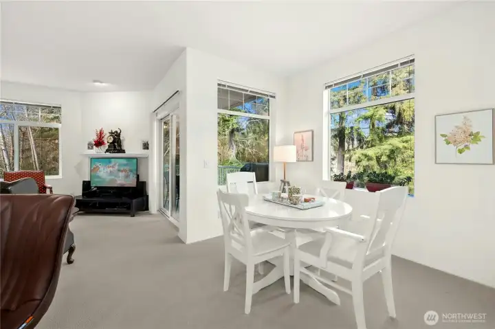 Large windows frame tranquil greenbelt views