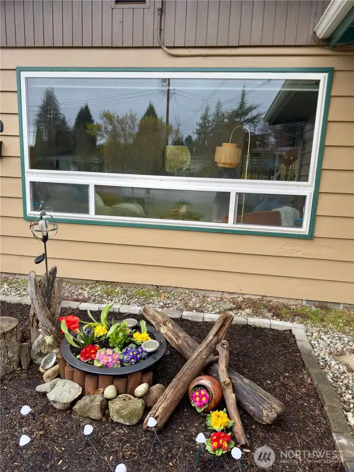 Colorful flower bed adds charm and a welcoming touch along the path to the front door.